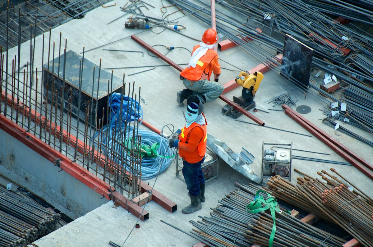 Illustrative construction site with workers coordinating building work